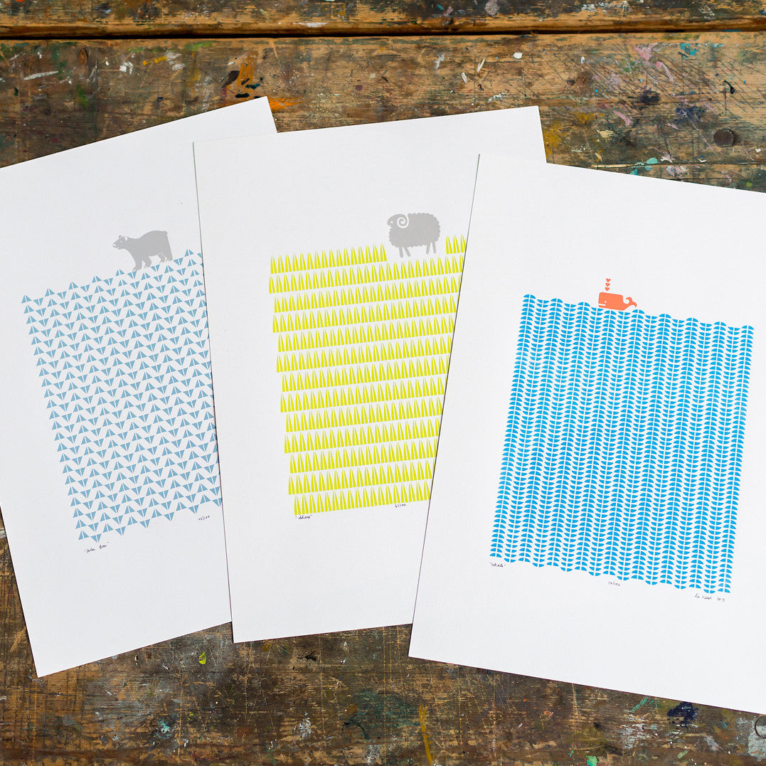 Nautical Scandinavian style print of a coral coloured whale in a graphic sea of cerulean blue waves.