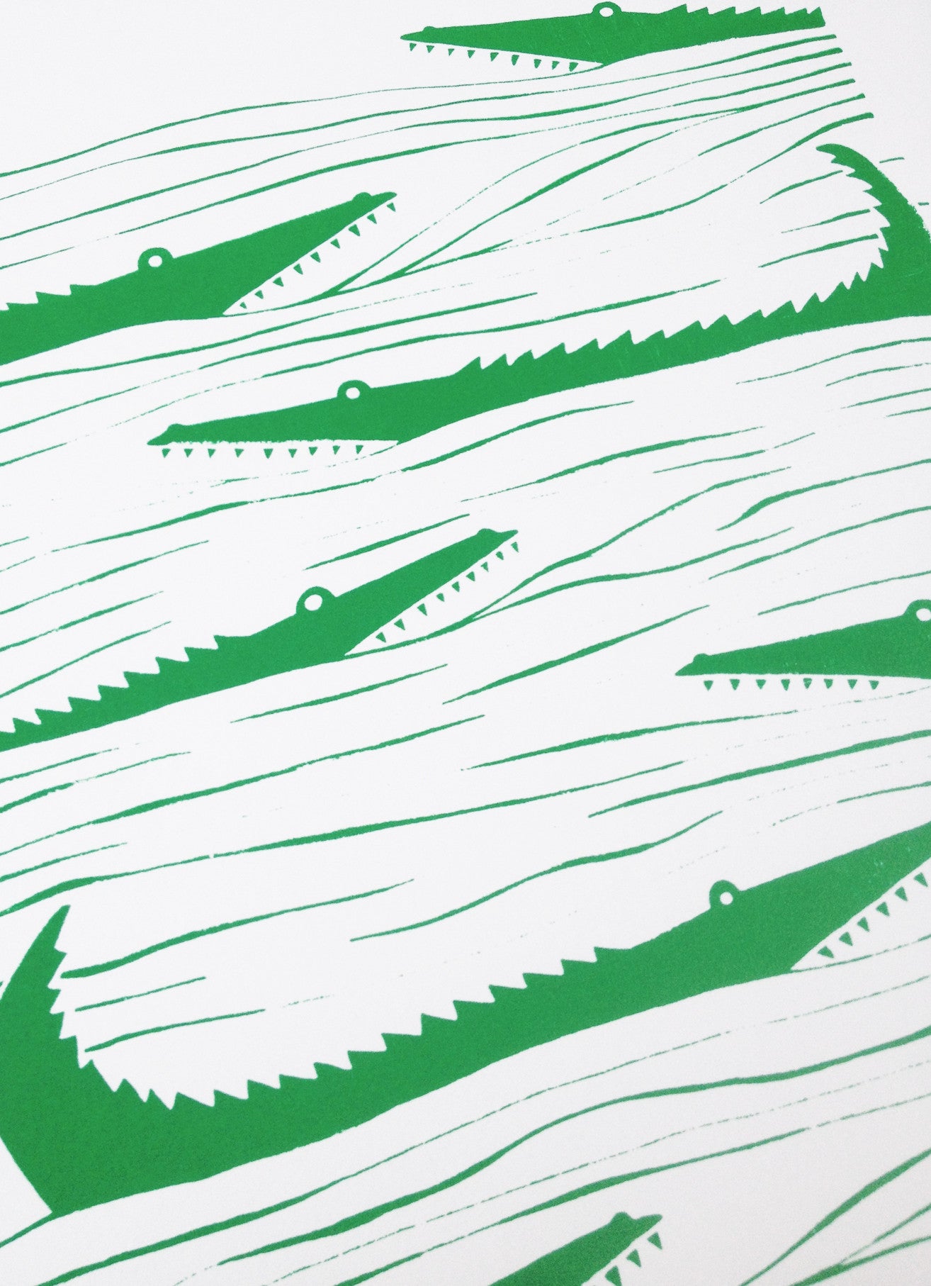 Graphic emerald green patterned art print of crocodiles lurking in the waters. Inspired by the simple shapes of animals found in African wood carvings.