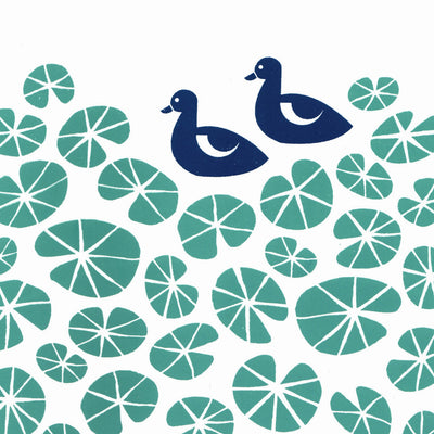 Delightful print of midnight blue ducks in a pond of green floating water lilies. The simple botanical patterns will bring a sense of calm to your home.