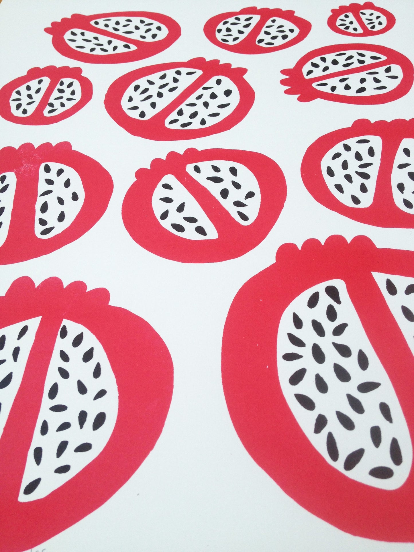 Scandinavian style kitchen wall art print of simple pomegranates. This bold red pattern of fruit creates contrast with the organic pomegranate seed shapes.