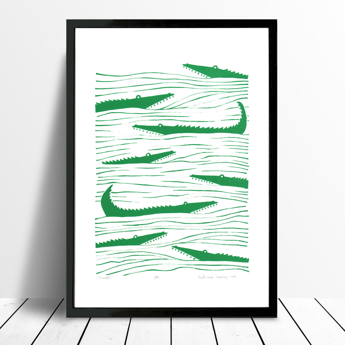 Graphic emerald green patterned art print of crocodiles lurking in the waters. Inspired by the simple shapes of animals found in African wood carvings.