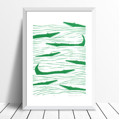 Graphic emerald green patterned art print of crocodiles lurking in the waters. Inspired by the simple shapes of animals found in African wood carvings.